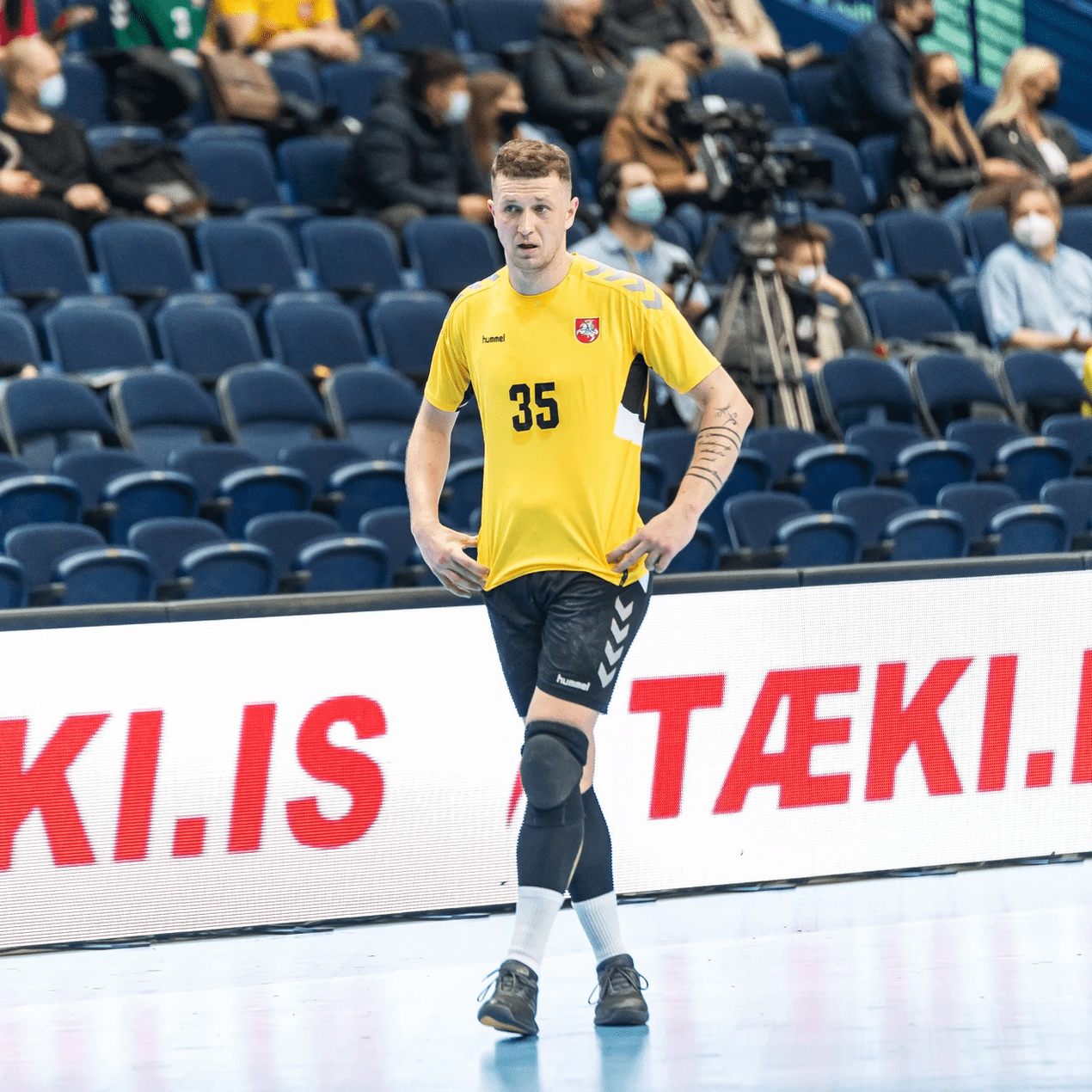 Handball player in front of a red LED perimeter board