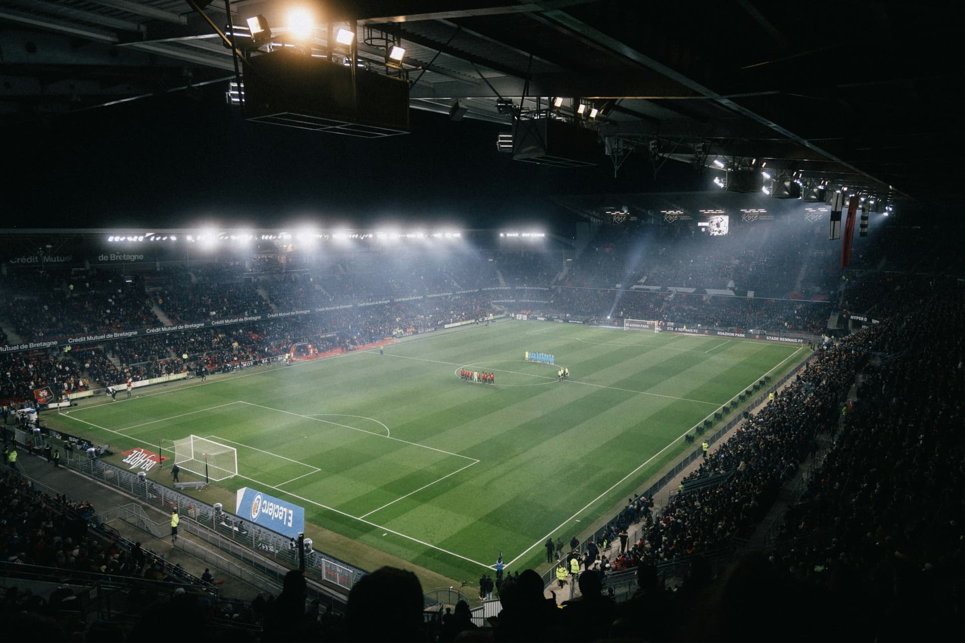 LED perimeter advertising boards at a floodlit stadium during a live match